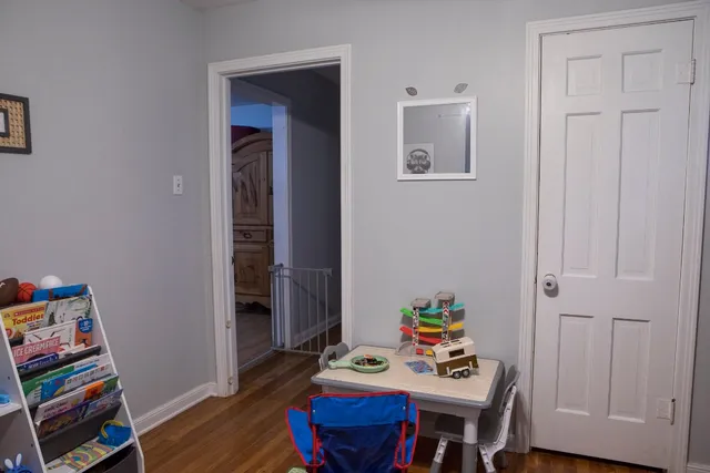a view of a workspace with furniture and wooden floor