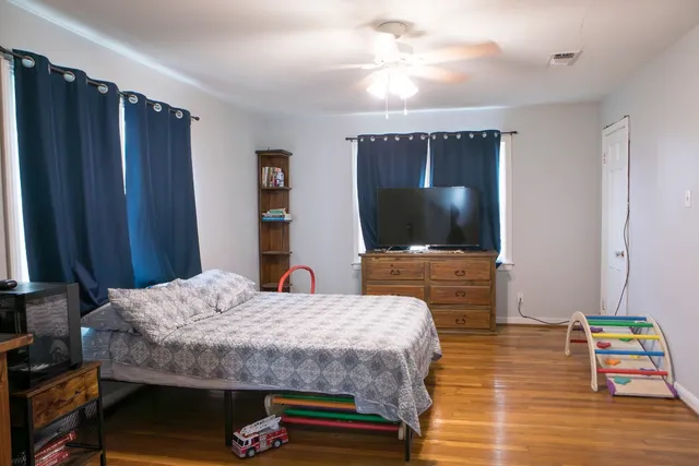 a bedroom with a bed and a flat screen tv