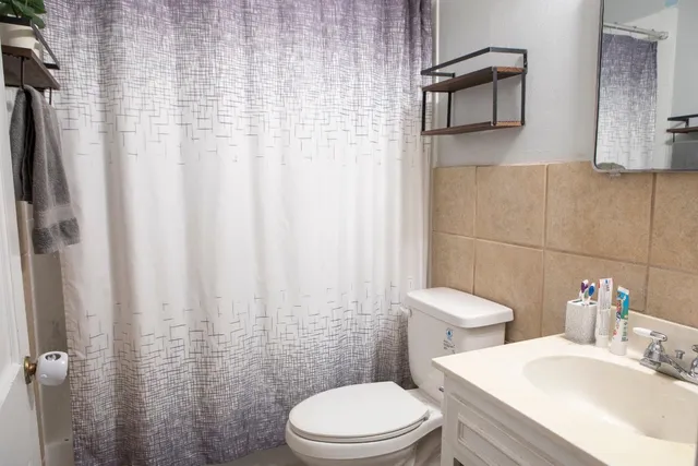 a white toilet sitting next to a bathroom sink