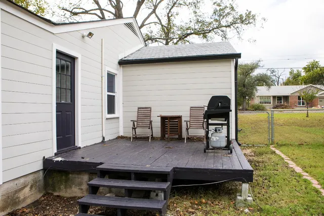 a house view with a sitting space fire pit and outdoor space