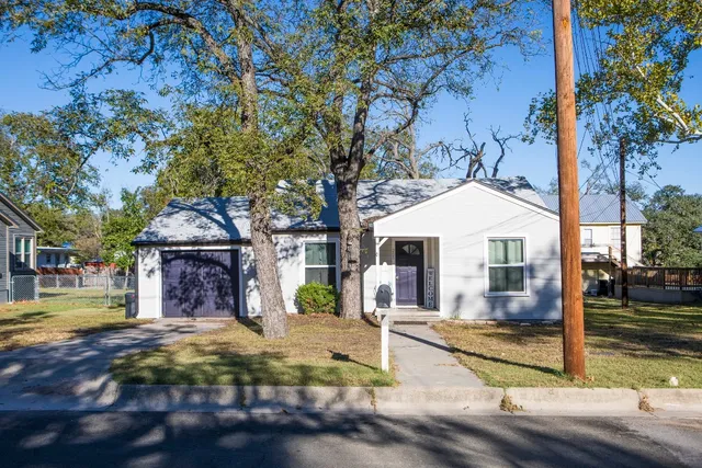 a view of the house with a yard
