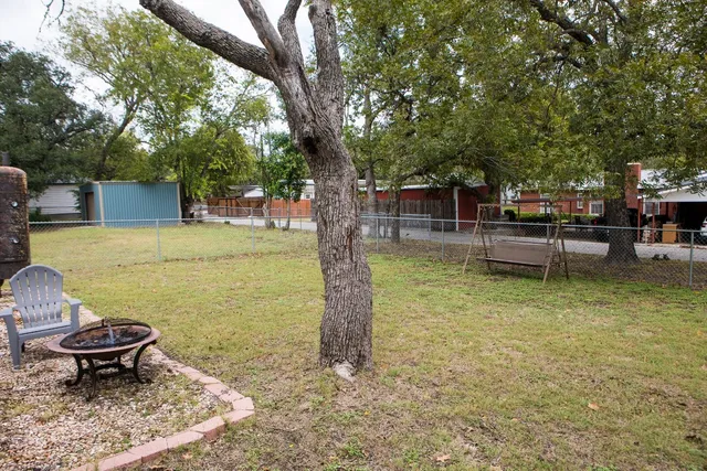 a swimming pool with some trees in the background