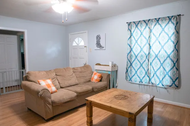 a living room with furniture and a chandelier