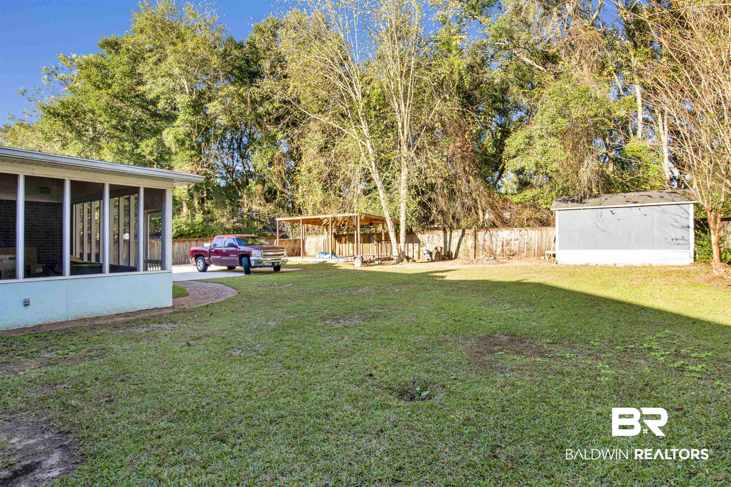 445 Wedgefield Drive South Mobile, AL 36608 - Photo 29 of 36 View of yard featuring a storage shed and a sunroom