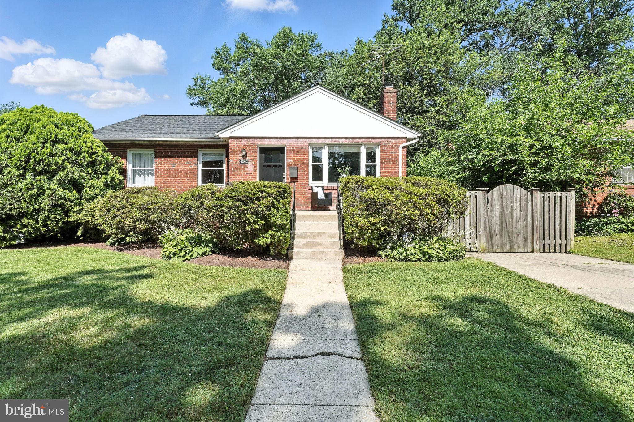 10002 Portland Place Silver Spring, MD 20901 - Photo 1 of 31 a front view of a house with garden