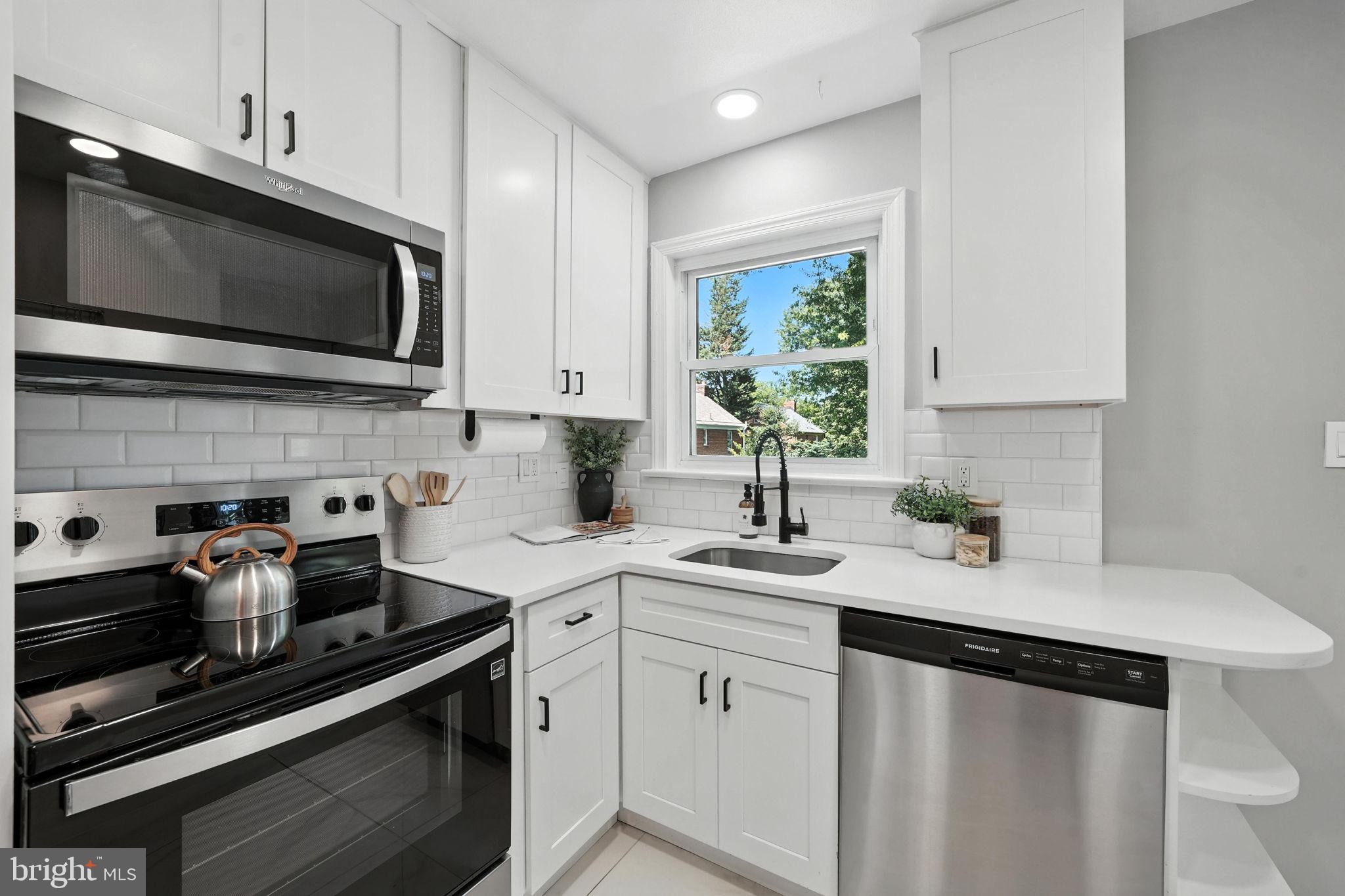 10002 Portland Place Silver Spring, MD 20901 - Photo 13 of 31 a kitchen with a sink stove and microwave