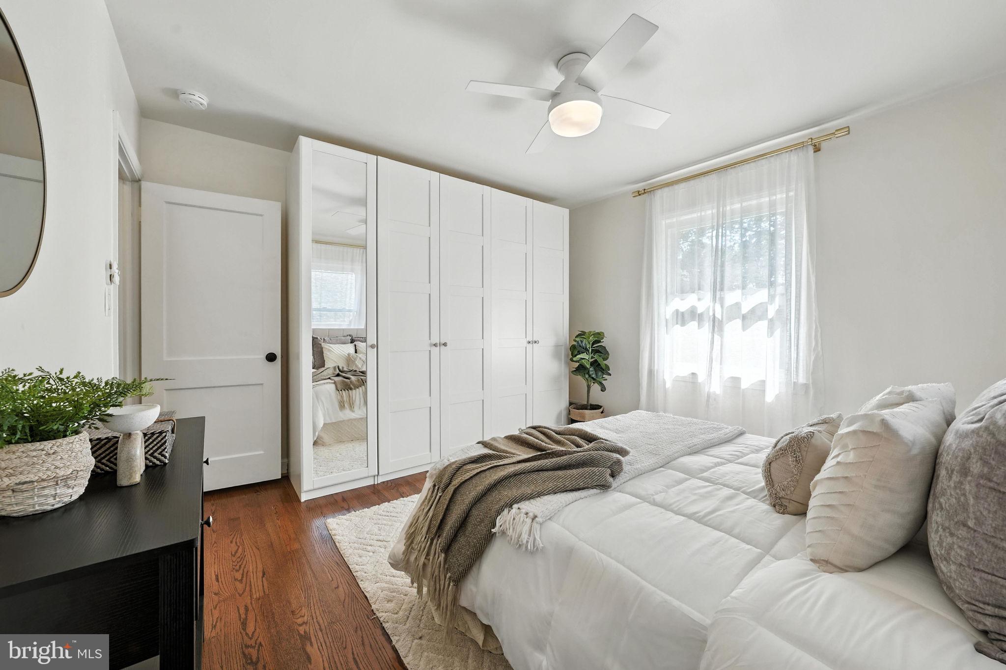 10002 Portland Place Silver Spring, MD 20901 - Photo 15 of 31 a spacious bedroom with a bed and a table in it