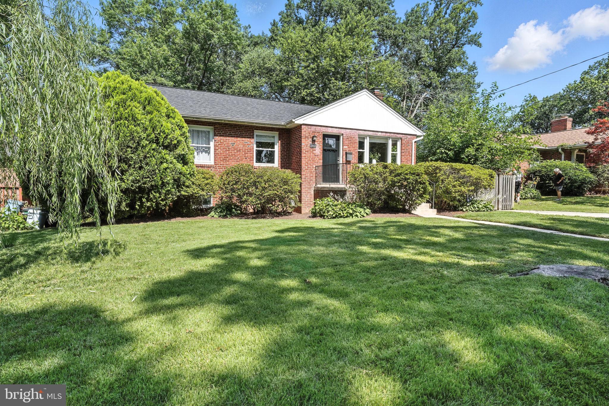 10002 Portland Place Silver Spring, MD 20901 - Photo 2 of 31 a front view of a house with a yard