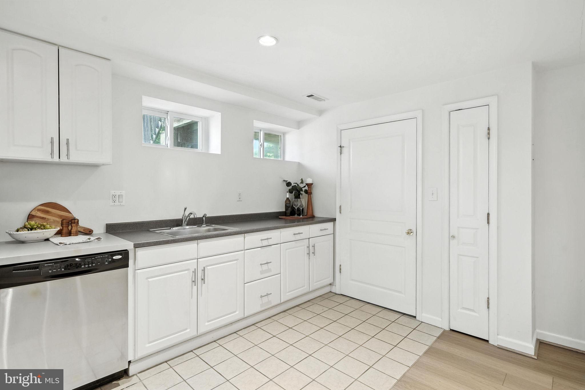10002 Portland Place Silver Spring, MD 20901 - Photo 23 of 31 a kitchen with granite countertop white cabinets and sink