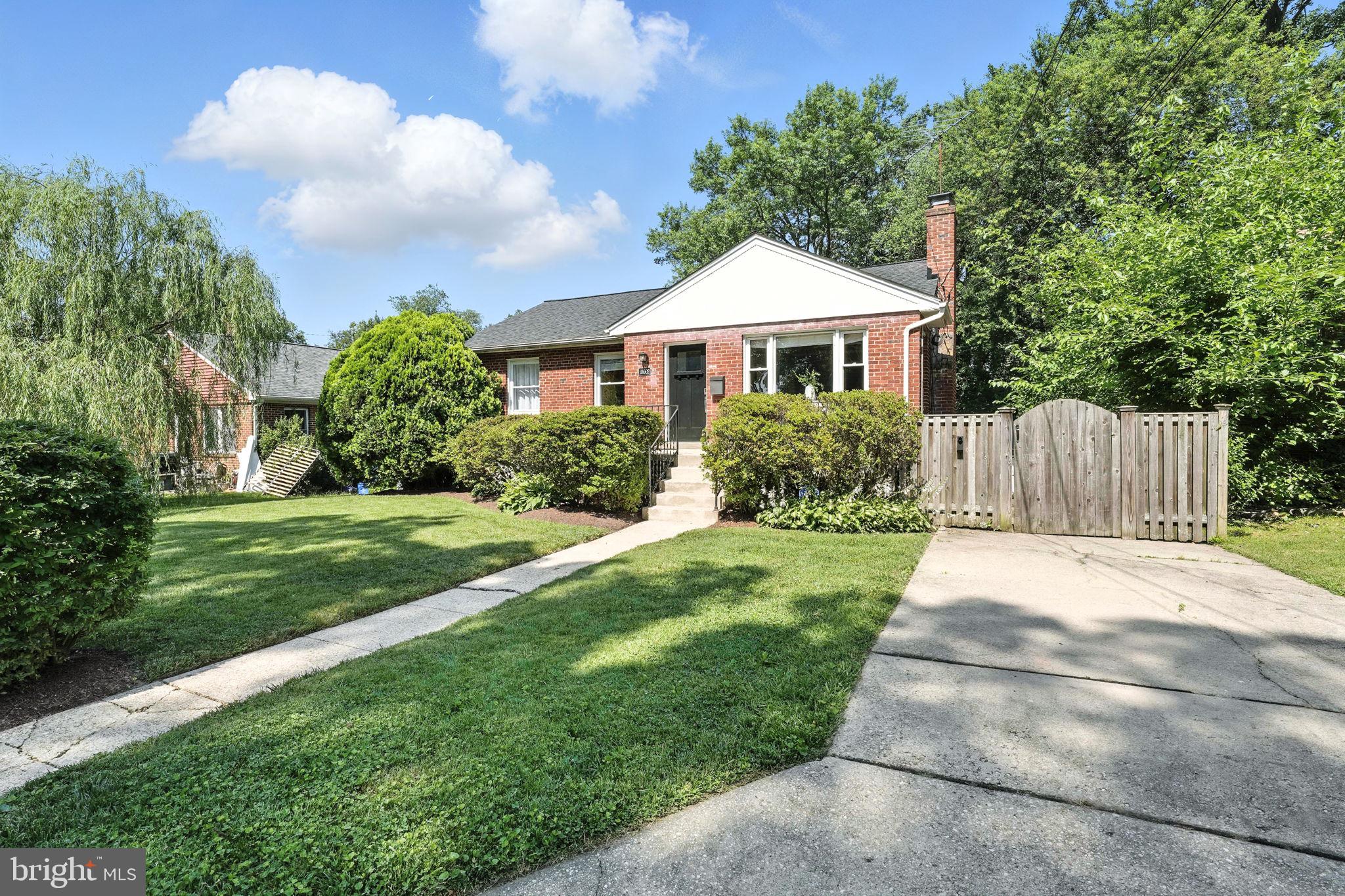 10002 Portland Place Silver Spring, MD 20901 - Photo 3 of 31 a front view of a house with garden