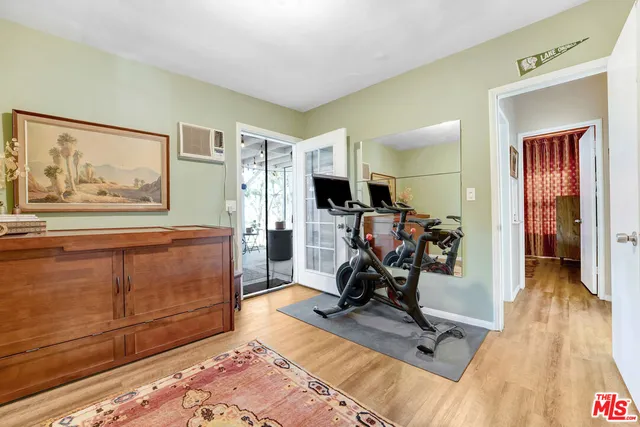 a view of a livingroom with furniture and gym equipment