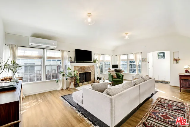 a living room with furniture fireplace and flat screen tv