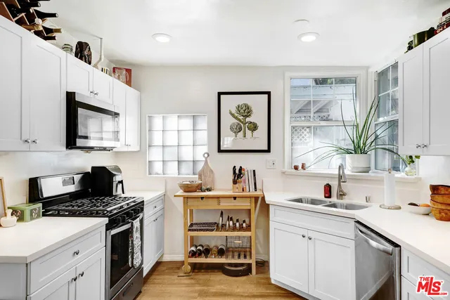 a kitchen with a sink stove and microwave