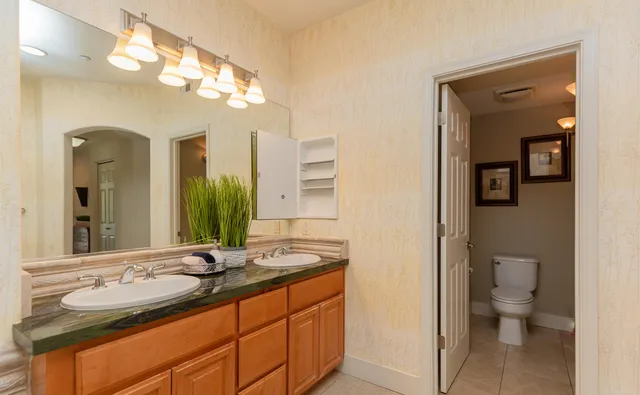 a bedroom with a bed table and a window