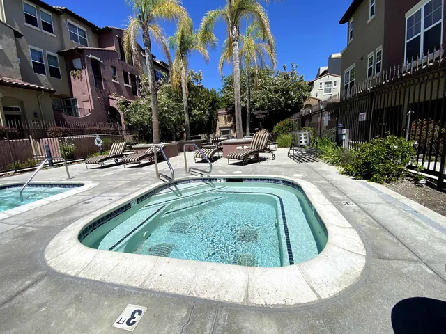 a view of a street with potted plants and trees