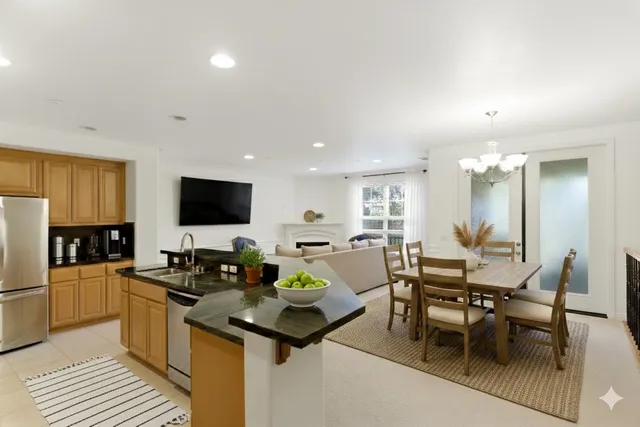 a kitchen with stainless steel appliances kitchen island granite countertop a sink and cabinets