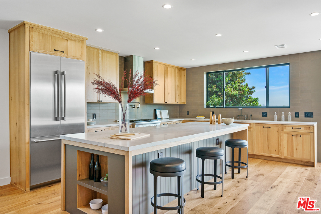 4132 Punta Alta Drive Los Angeles, CA 90008 - Photo 18 of 43 a kitchen with stainless steel appliances granite countertop a sink and a refrigerator