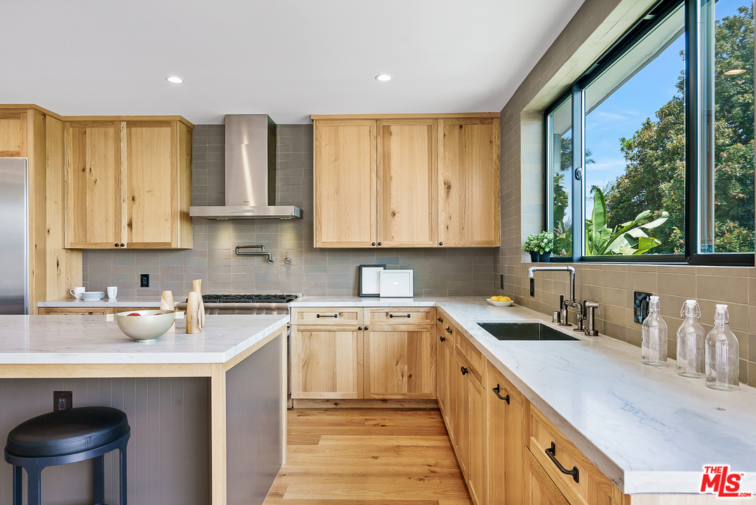 4132 Punta Alta Drive Los Angeles, CA 90008 - Photo 19 of 43 a kitchen with a sink stove and cabinets