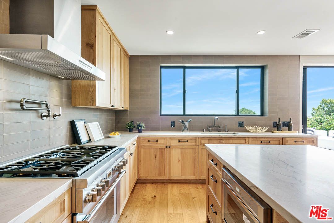 4132 Punta Alta Drive Los Angeles, CA 90008 - Photo 21 of 43 a kitchen with a sink stove top oven and cabinets