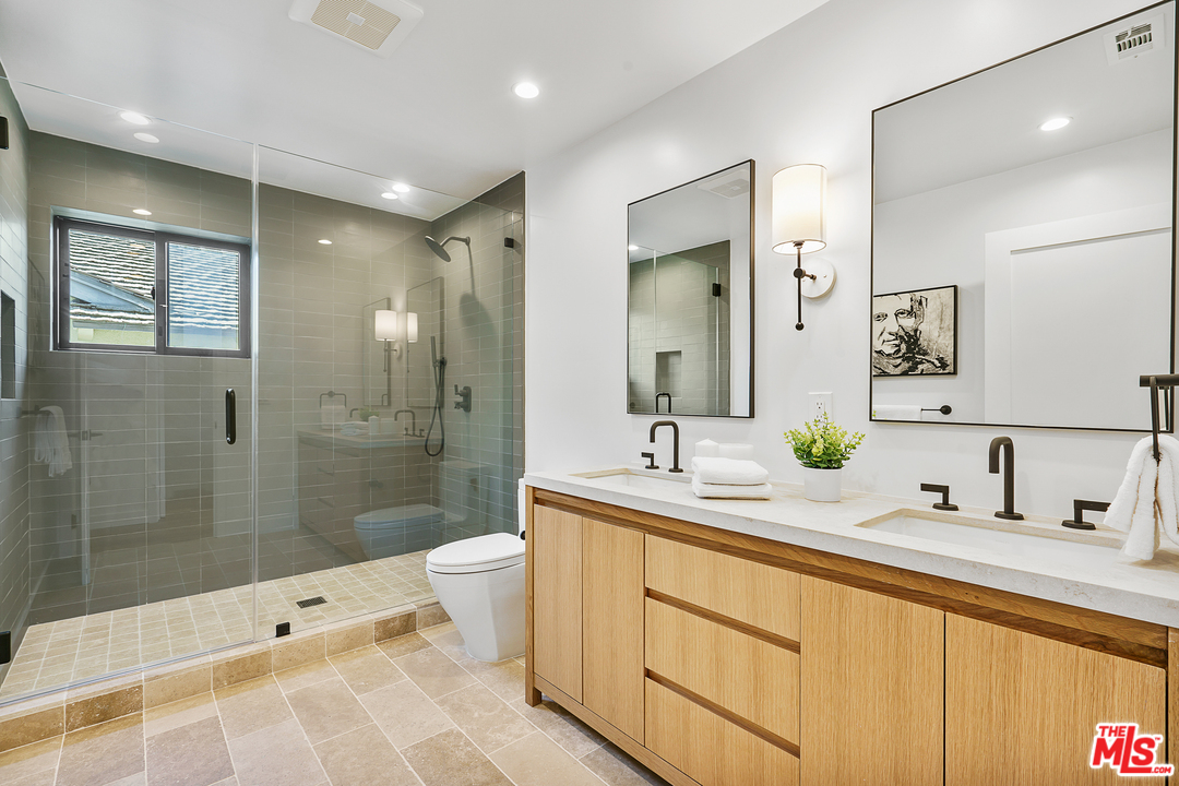 4132 Punta Alta Drive Los Angeles, CA 90008 - Photo 34 of 43 a bathroom with a double vanity sink toilet mirror and shower
