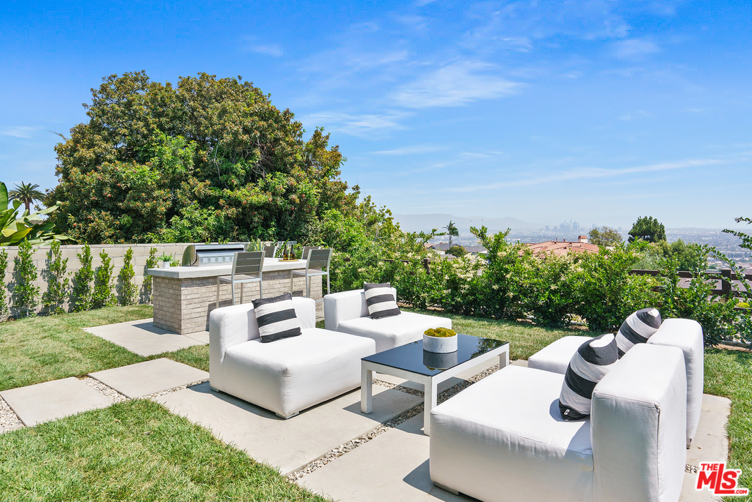 4132 Punta Alta Drive Los Angeles, CA 90008 - Photo 36 of 43 a view of a patio with couches table and chairs and potted plants