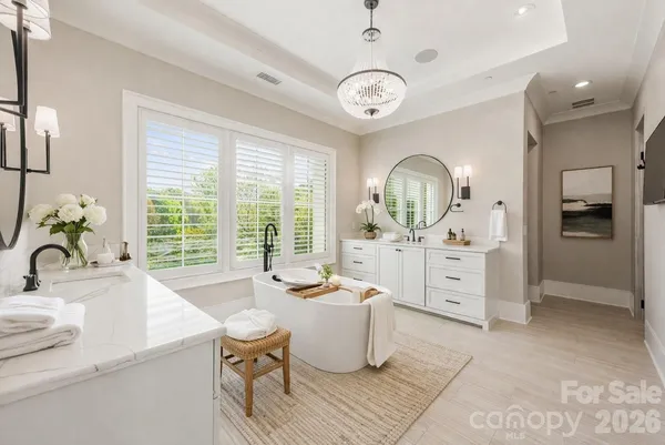 a large white kitchen with a large window