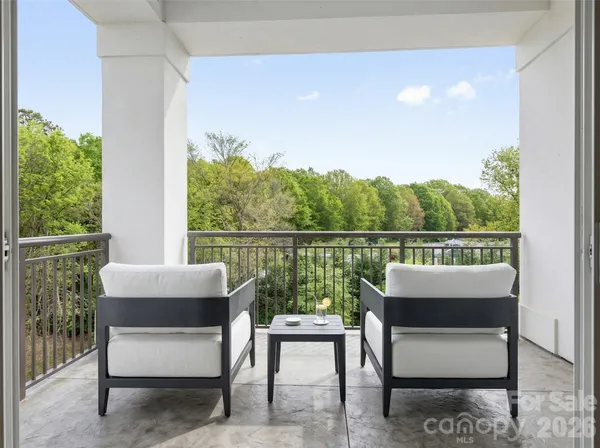 a view of two chairs in the balcony