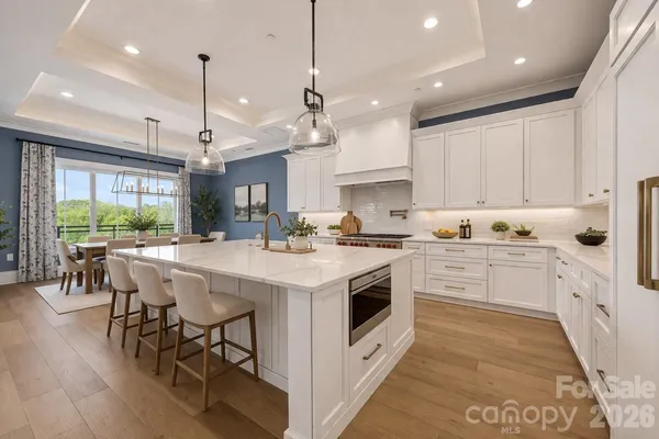 a kitchen with a stove a table and chairs