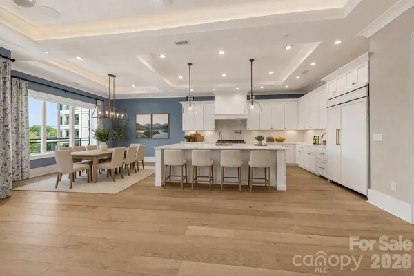 a kitchen with stainless steel appliances kitchen island granite top and refrigerator
