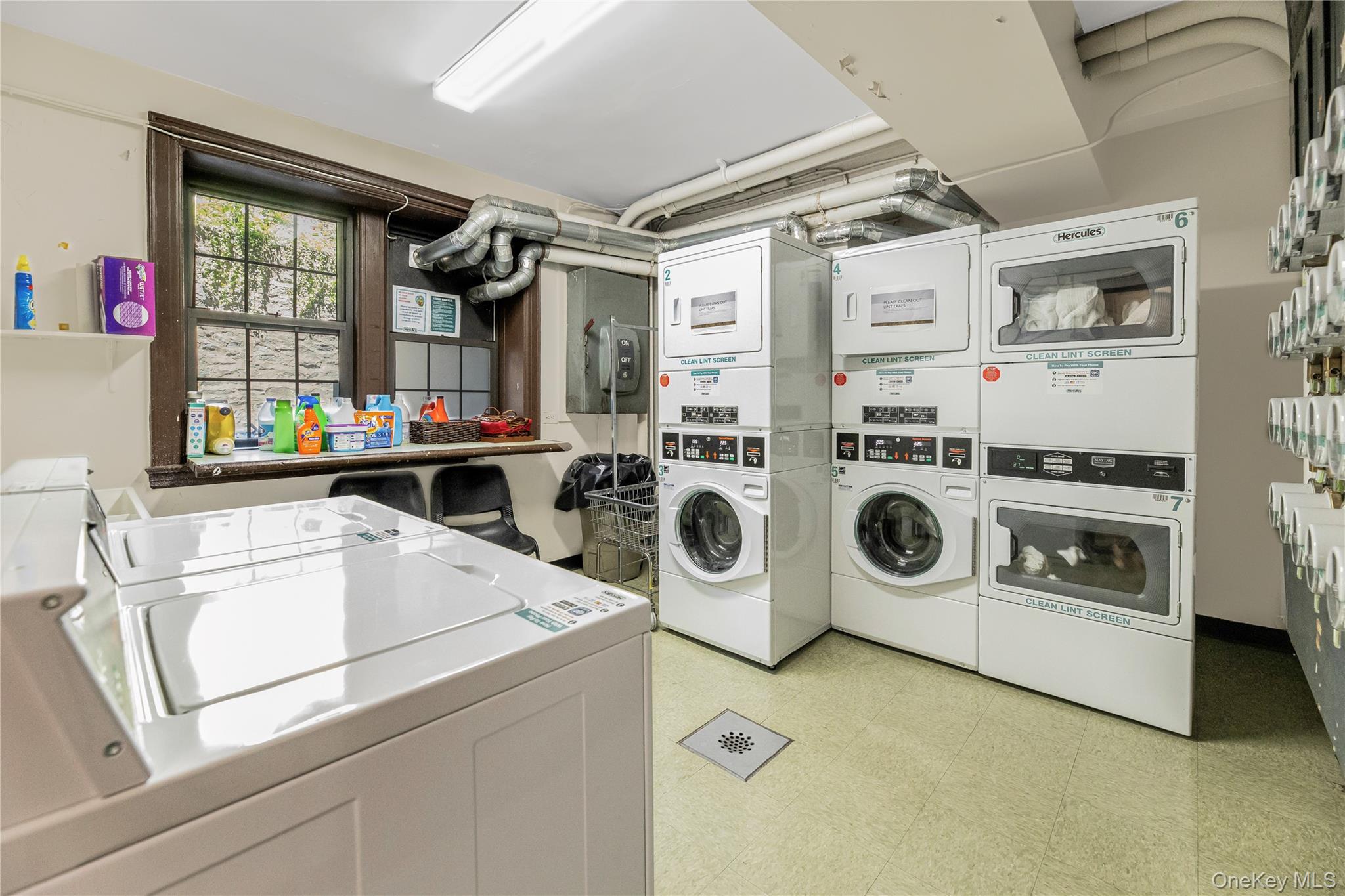 26 Pondfield Road, Unit 1D Bronxville, NY 10708 - Photo 18 of 21 a utility room with dryer and washer