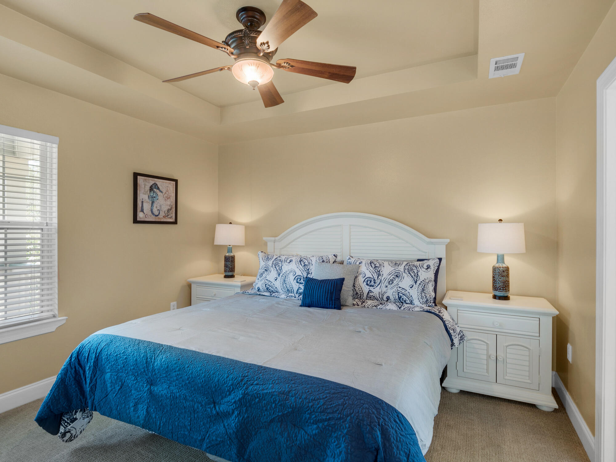 4587 Woodwind Drive Destin, FL 32541 - Photo 12 of 24 a bedroom with a bed and a chandelier