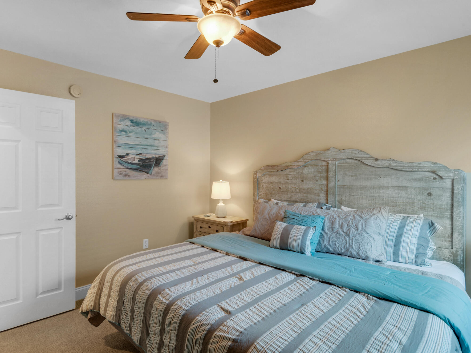 4587 Woodwind Drive Destin, FL 32541 - Photo 14 of 24 a bedroom with a bed and a chandelier