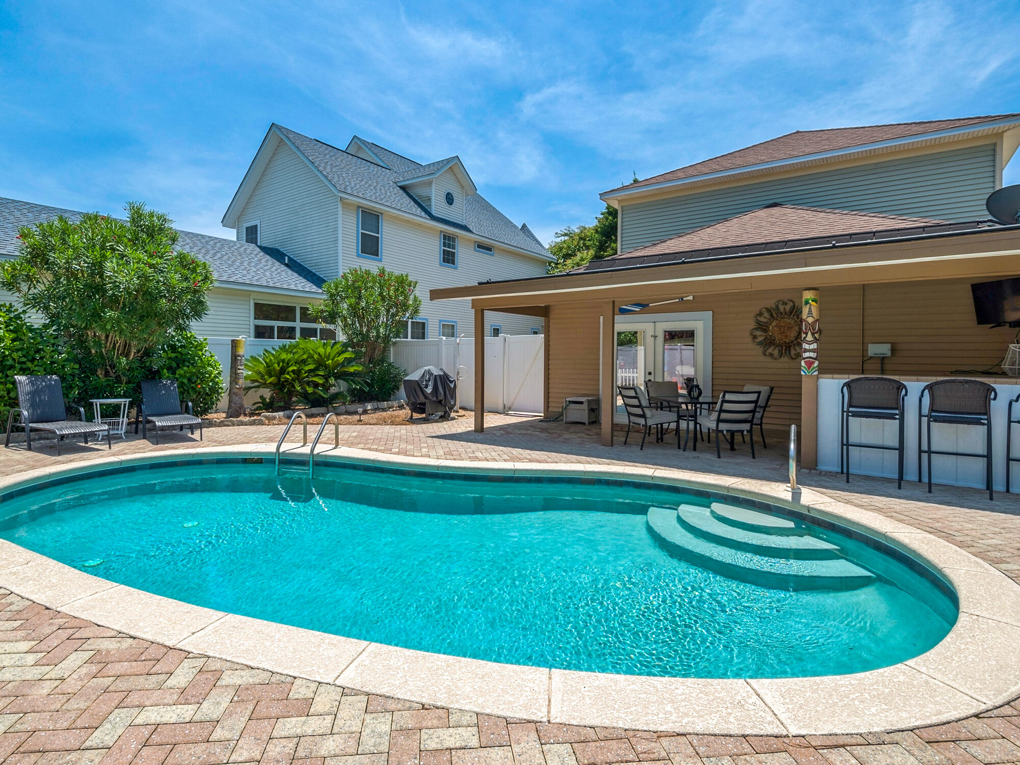 4587 Woodwind Drive Destin, FL 32541 - Photo 20 of 24 a swimming pool with outdoor seating and yard