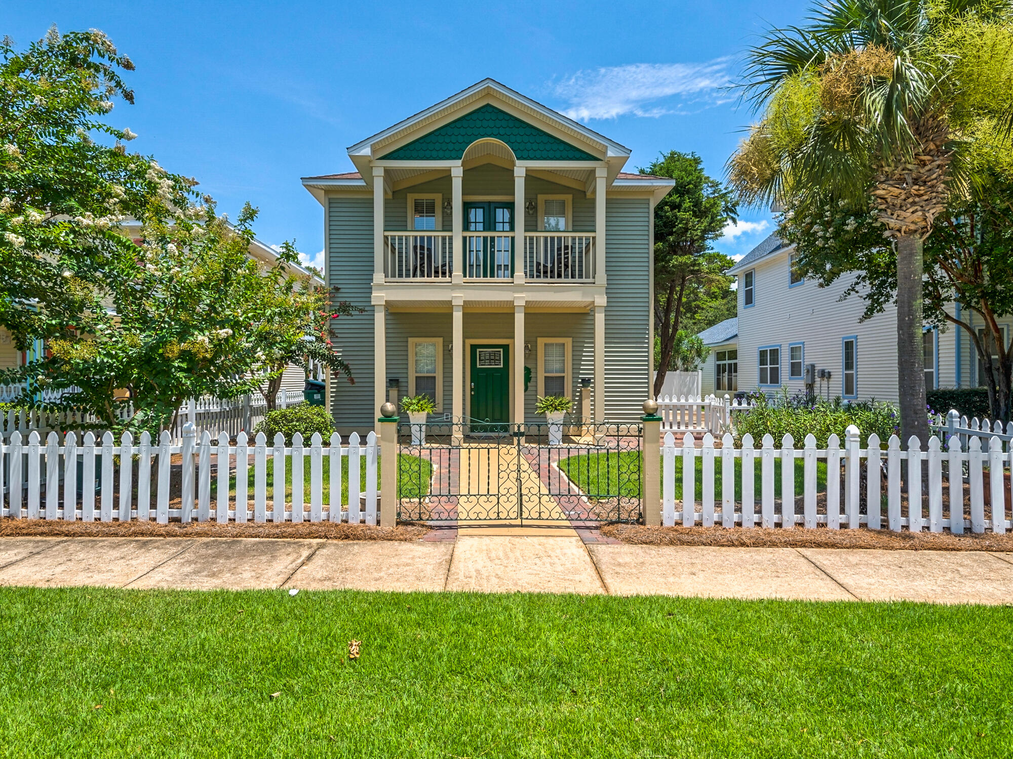 4587 Woodwind Drive Destin, FL 32541 - Photo 2 of 24 a view of a house with a yard and a garden
