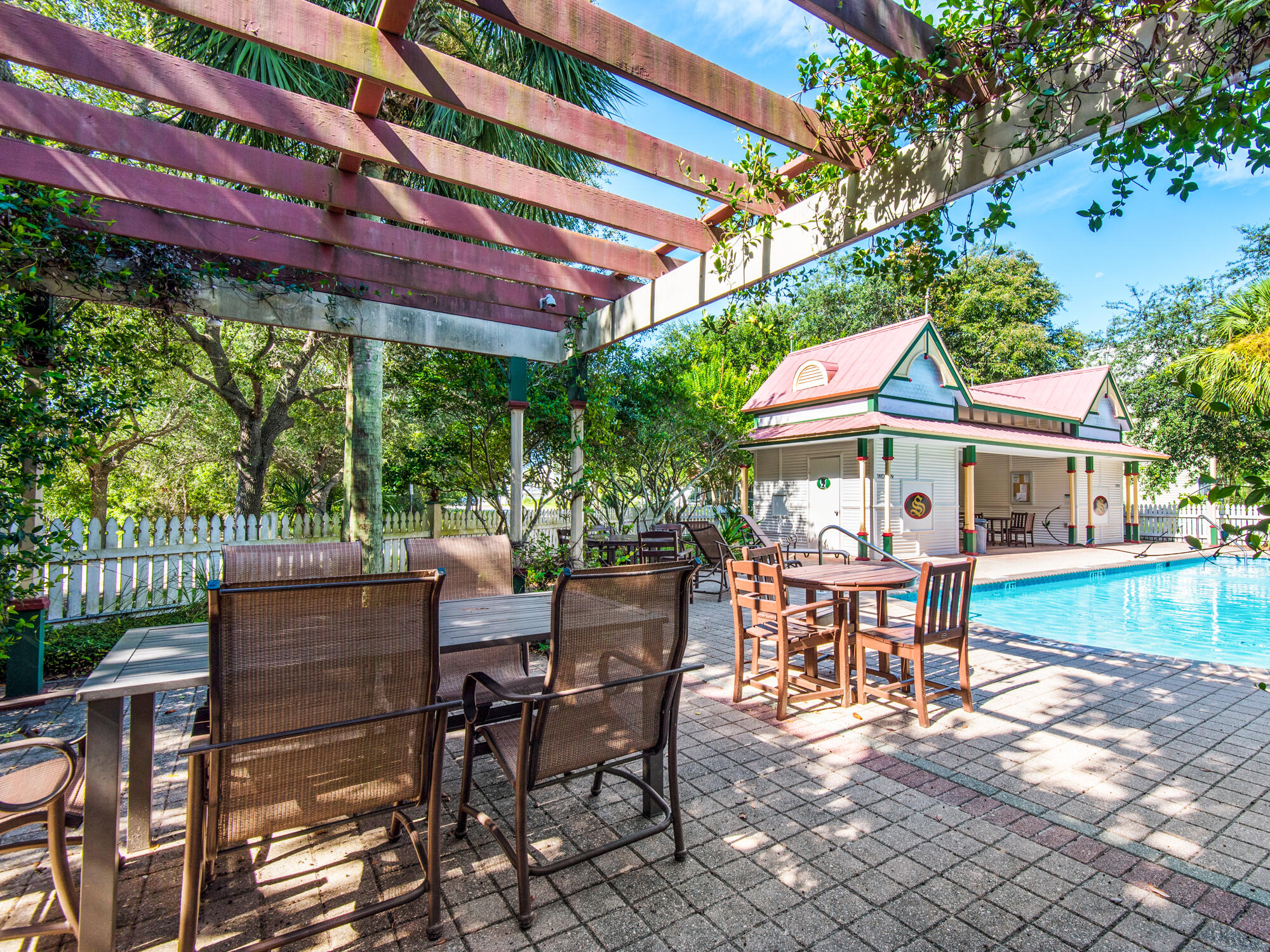 4587 Woodwind Drive Destin, FL 32541 - Photo 24 of 24 a view of a patio with a table and chairs under an umbrella