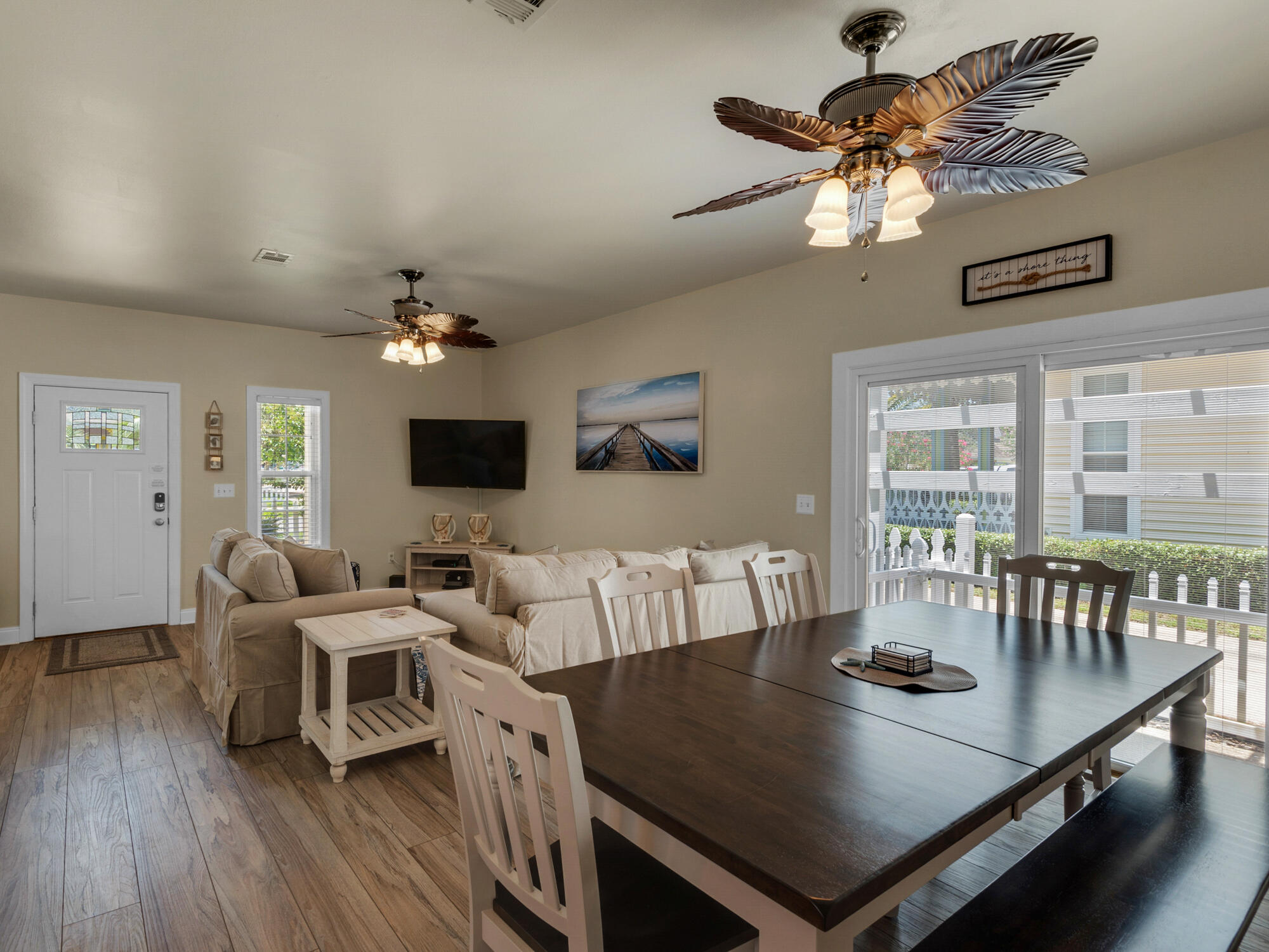 4587 Woodwind Drive Destin, FL 32541 - Photo 5 of 24 a living room with furniture and a flat screen tv