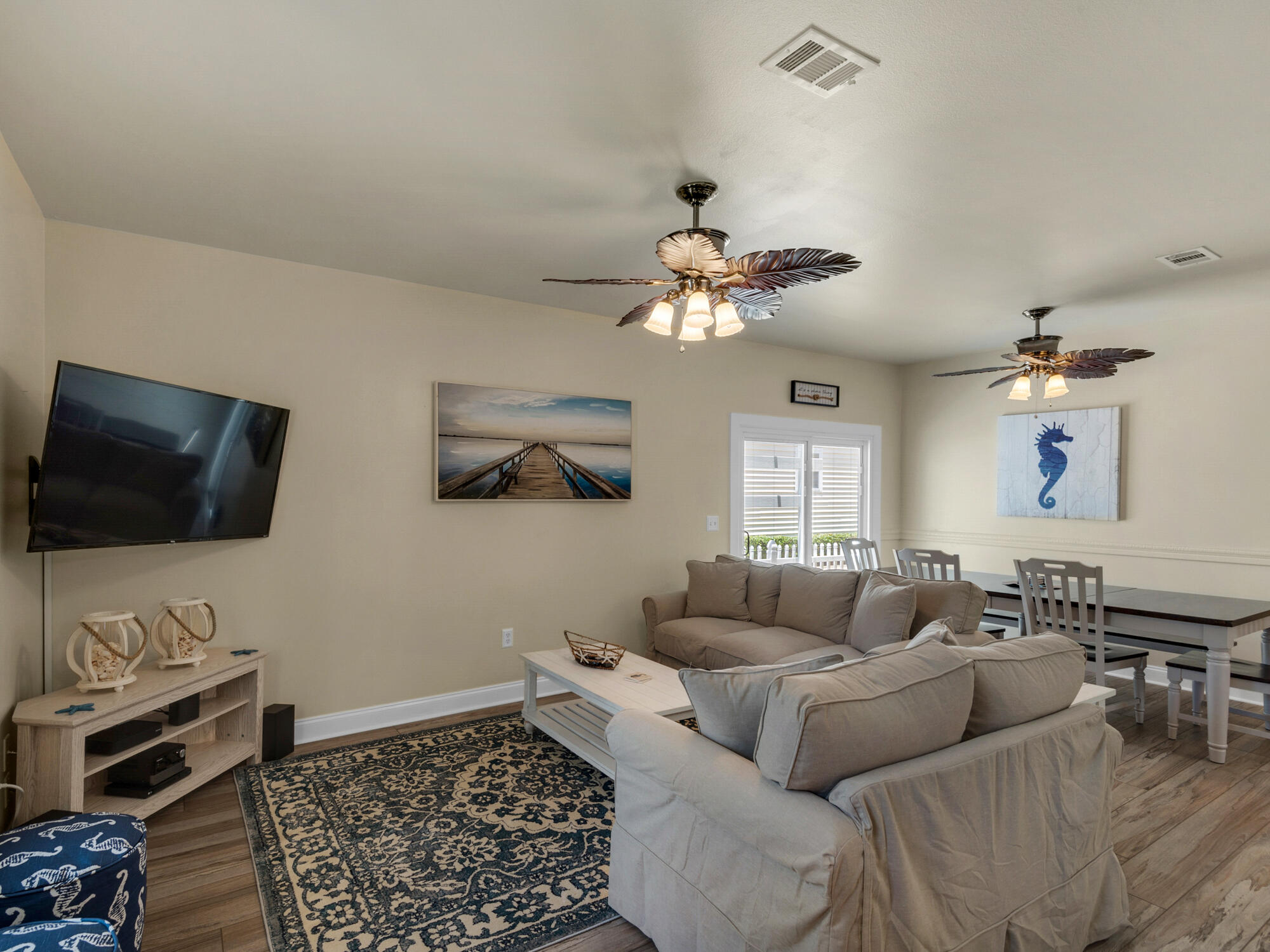 4587 Woodwind Drive Destin, FL 32541 - Photo 6 of 24 a living room with furniture and a flat screen tv