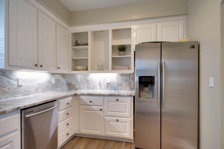 4587 Woodwind Drive Destin, FL 32541 - Photo 10 of 24 a kitchen with cabinets stainless steel appliances and a counter space