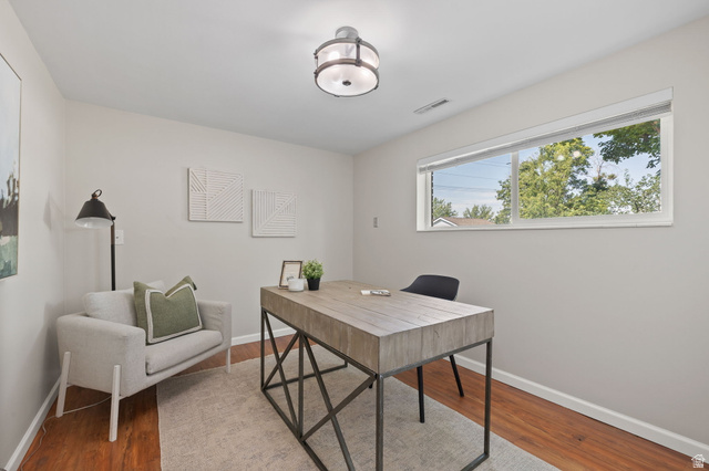 2370 Quail Run Circle East Sandy, UT 84093 - Photo 25 of 54 Versatile room with wood-finish flooring, a large horizontal window, and a contemporary flush-mount ceiling light