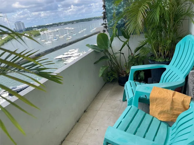 a view of balcony with wooden floor and seating space
