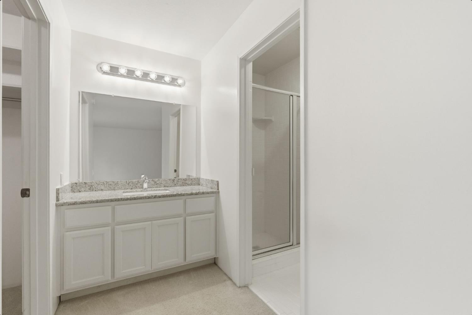 524 Hartnell Place Sacramento, CA 95825 - Photo 13 of 25 a bathroom with a granite countertop sink and a mirror