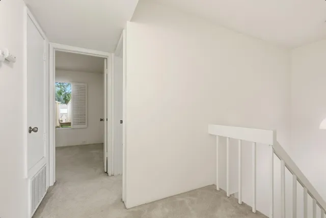 a view of a hallway with a wooden cabinets