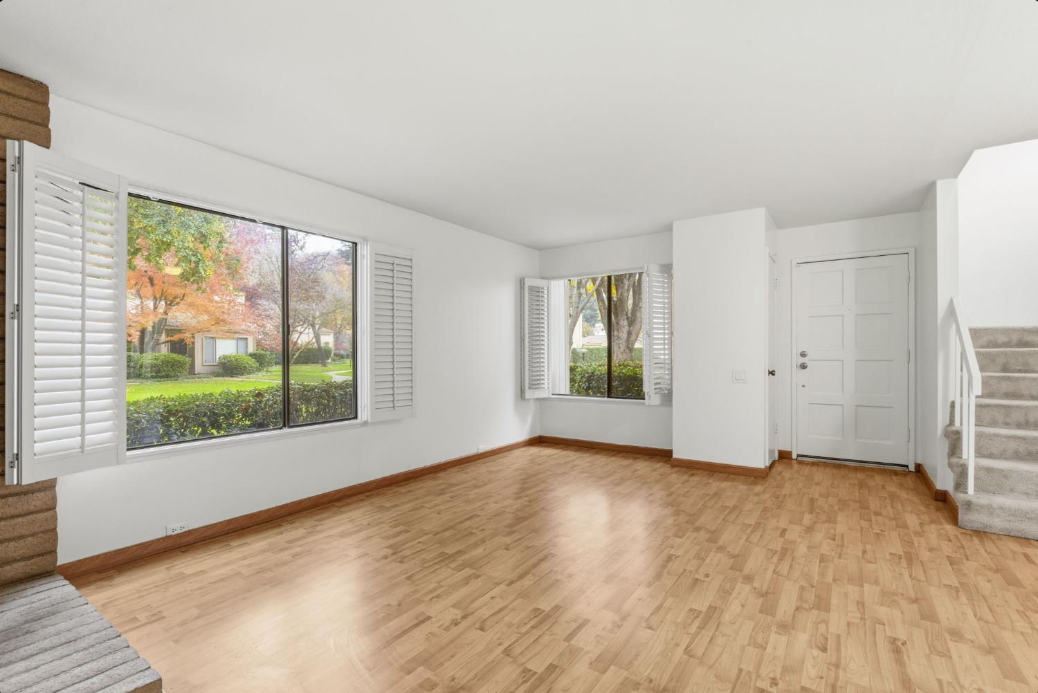 524 Hartnell Place Sacramento, CA 95825 - Photo 6 of 25 a view of an empty room with a window and wooden floor