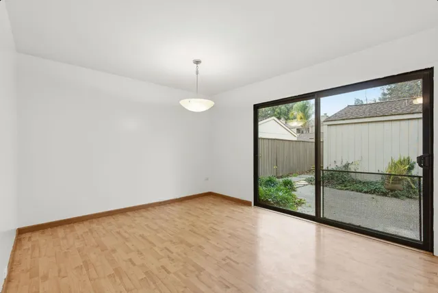 a view of an empty room with windows