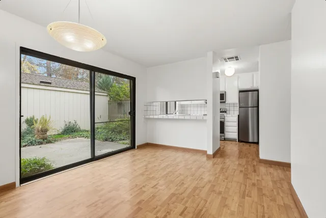 a view of a kitchen with a sink and refrigerator