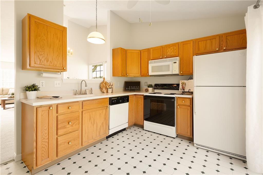 146 Sedeca Drive Canonsburg, PA 15317 - Photo 6 of 41 a kitchen with granite countertop a refrigerator a sink dishwasher and white cabinets with wooden floor