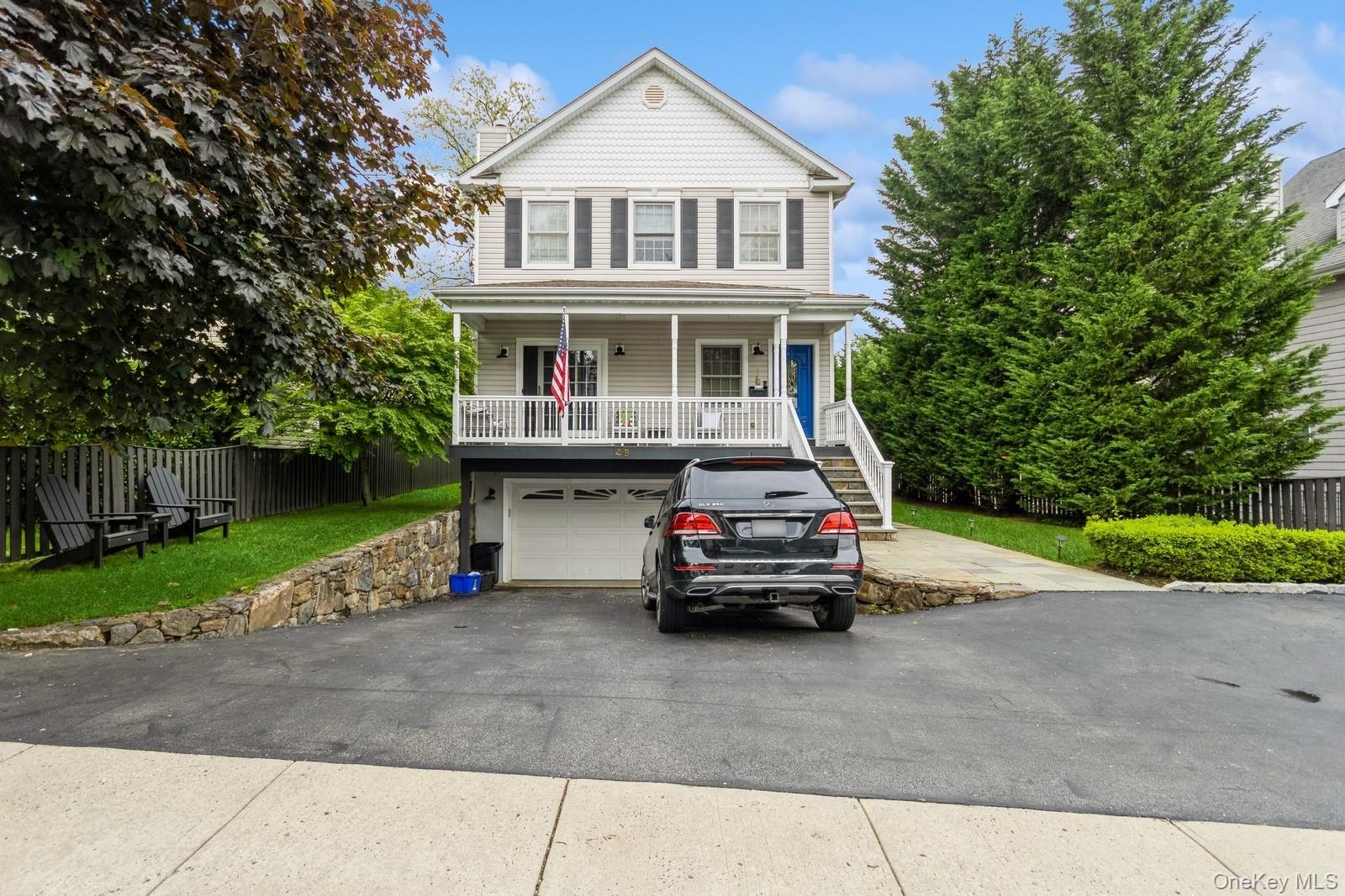 a car parked in front of white house