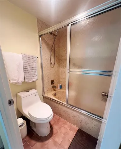 a living room with furniture pool table wooden floor and windows