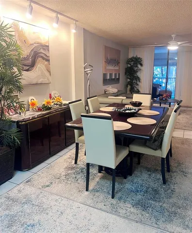 a bathroom with a granite countertop toilet sink and mirror