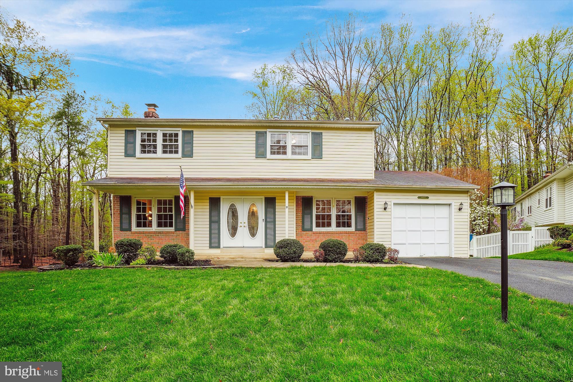 a front view of a house with a garden and plants